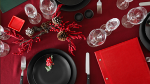 A sample red & gold Christmas restaurant place setting being tested out during the Christmas procurement planning process in the hospitality industry